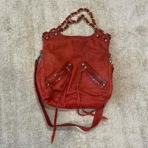 Distressed burnt orange with gold finishes over the arm or cross body bag